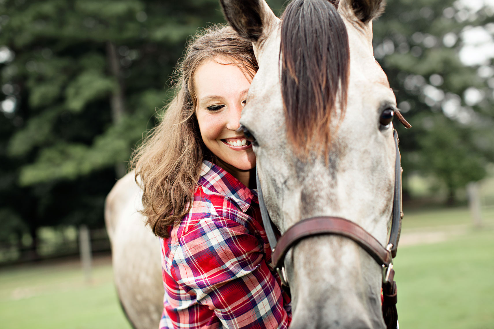 Young woman hugs neck of horse. By Atlanta photographer Nick Burchell