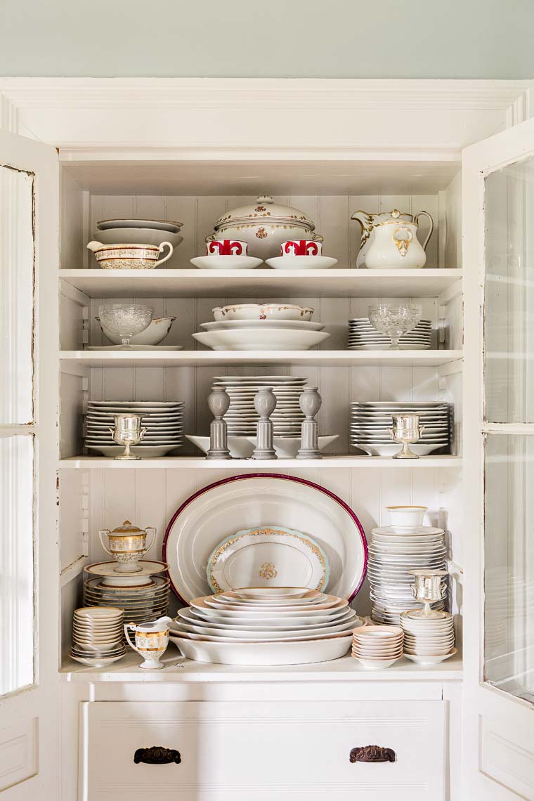 White tableware in country buffet hutch by Atlanta photographer
