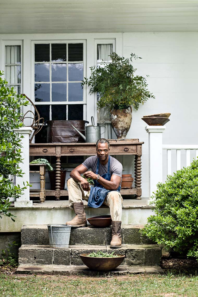 African American farmer shucking beans on steps of home by Atlanta photographer
