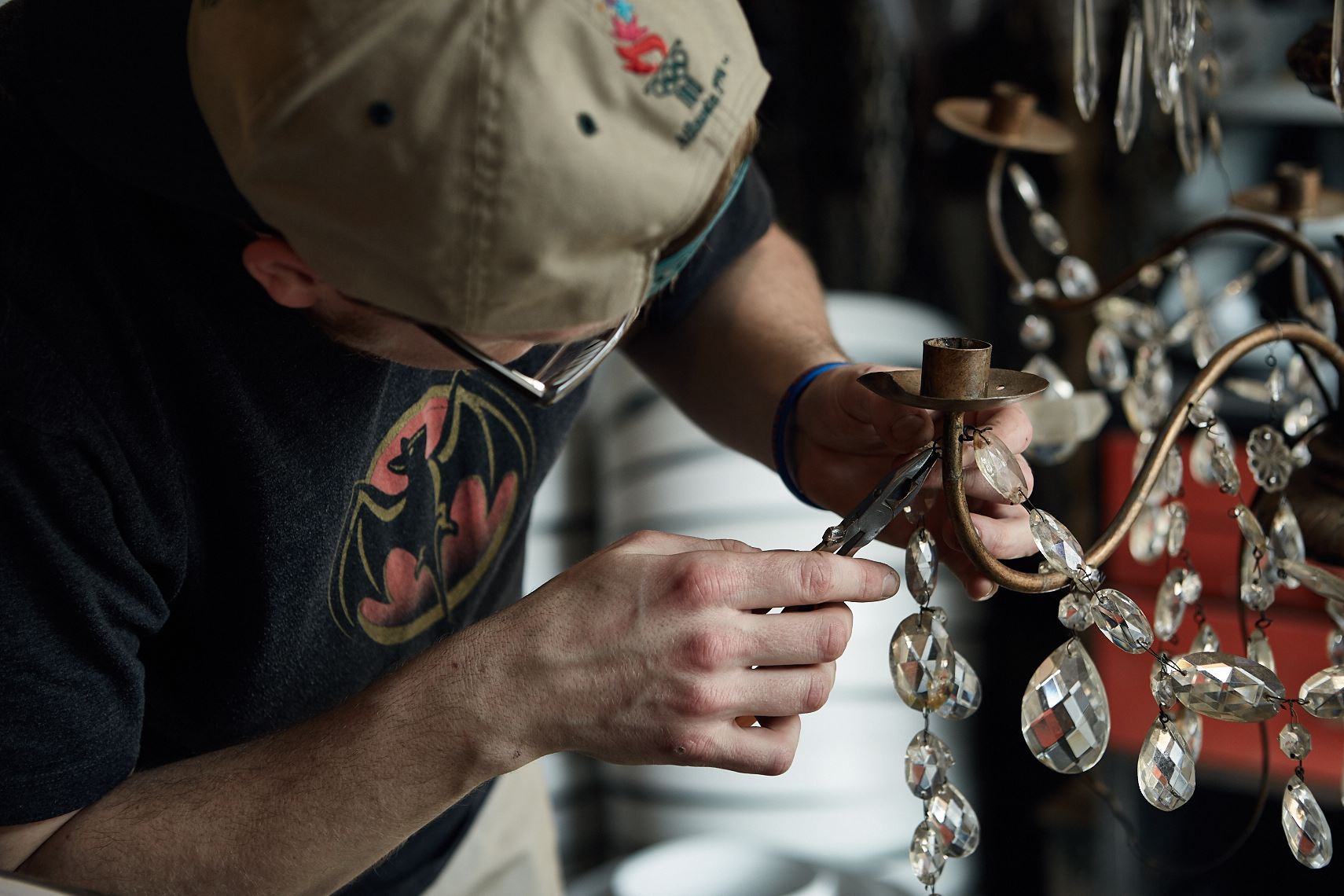 Craftsman repairs antique chandelier, Atlanta. Photographer Nick Burchell