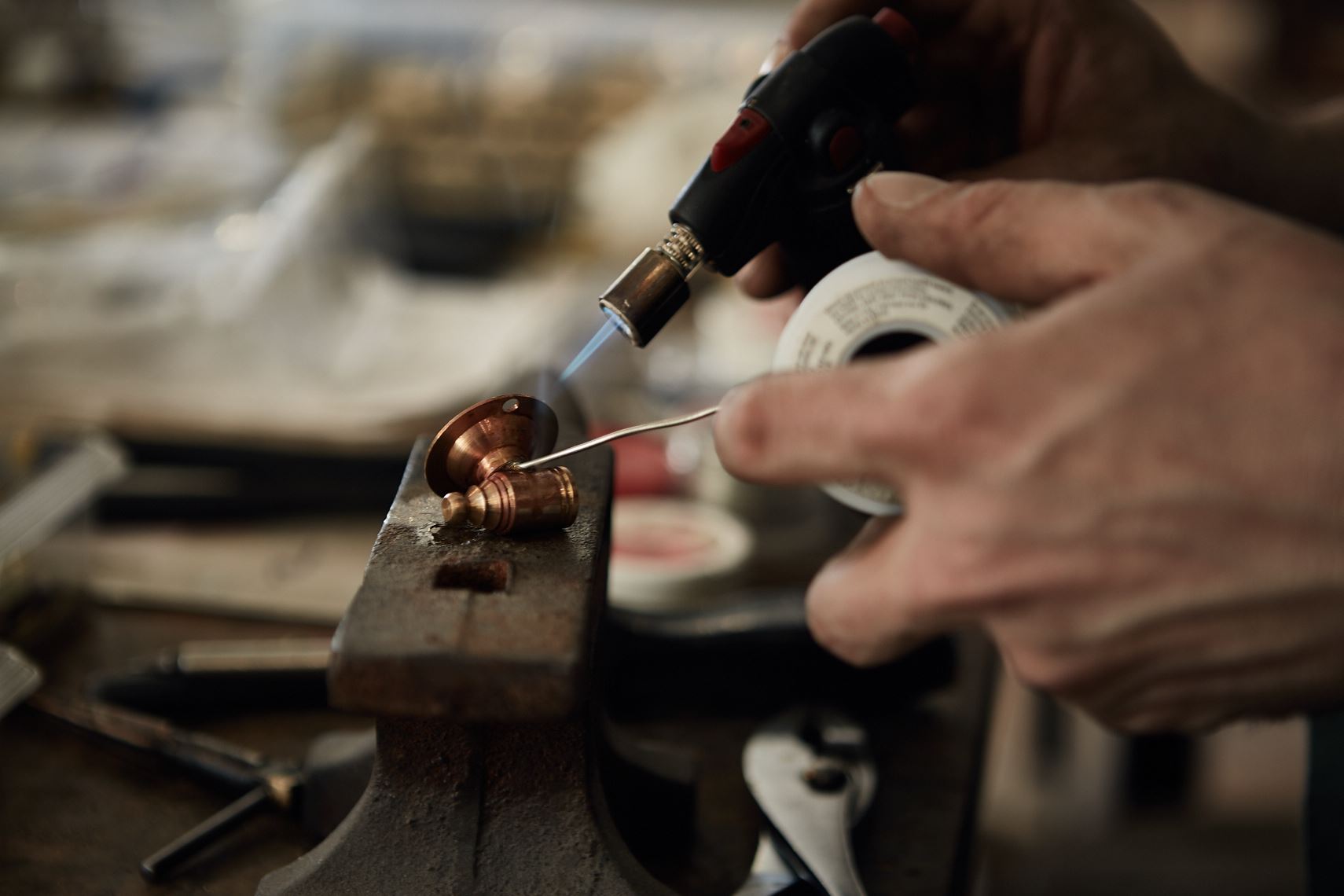 Soldering a part at Lighting Lab, Atlanta by lifestyle photographer