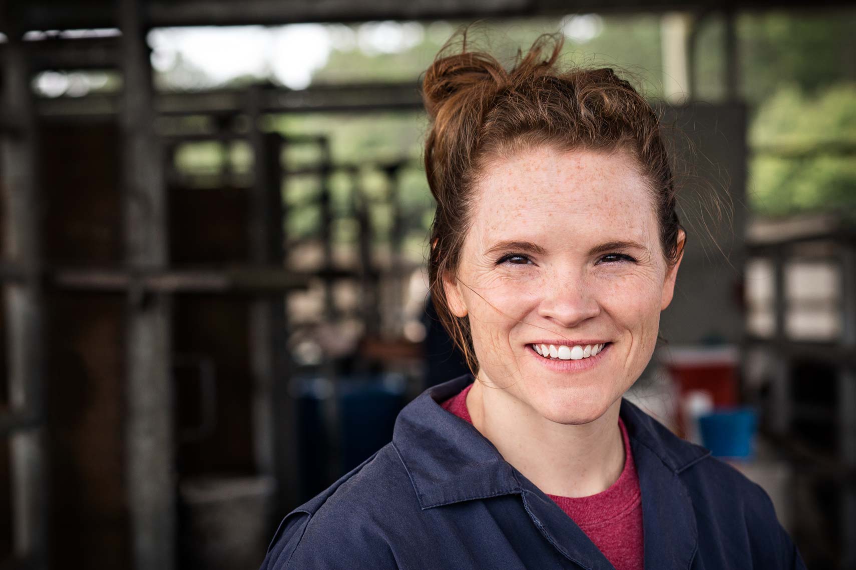 Lifestyle portrait of female farm worker smiling at photographer Nick Burchell