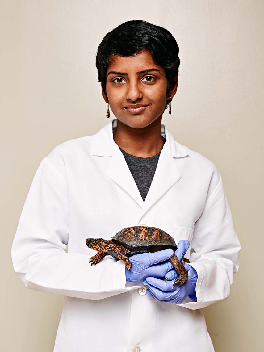 Photograph of veterinarian holding injured turtle, photographer Nick Burchell 